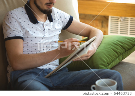 Man working from home during coronavirus or COVID-19 quarantine, remote office concept 64463733