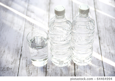 Cup of water and plastic bottle 64464994