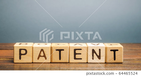Wooden blocks with the word Patent. Form of intellectual property. Document attesting the right of an inventor to his invention. 64465524