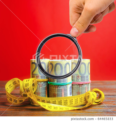Euro bills and measuring tape. The concept of business and finance. Profit and income analysis. Capital and budget. Saving money. Planning and management. Limited budget. Financial crisis 64465833
