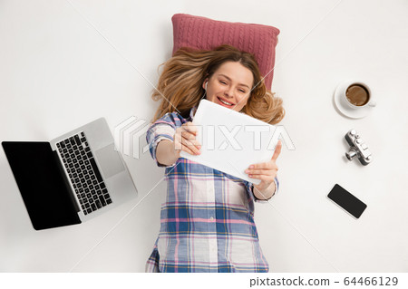 Emotional caucasian woman using gadgets isolated on white studio background, technologies conncecting people. Online shopping, selfie, gaming Emotional caucasian woman using gadgets isolated on white studio background, technologies conncecting people. Online shopping, selfie, gaming 64466129