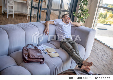 Young man spedning time at home and feeling sleepy Young man spedning time at home and feeling sleepy 64466566