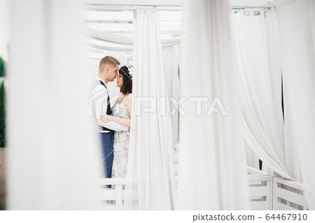 Romantic wedding moment, couple of newlyweds smiling portrait, bride and groom hugging Romantic wedding moment, couple of newlyweds smiling portrait, bride and groom hugging 64467910