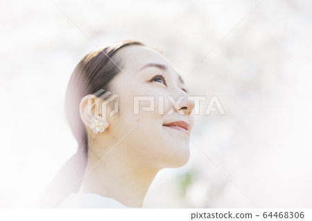 A woman with cherry blossoms in full bloom and oriental beauty 64468306