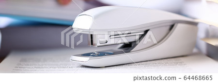 White stapler on workplace White stapler on workplace 64468665