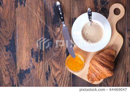 Cappuccino and croissant with orange jam Cappuccino and croissant with orange jam 64469047