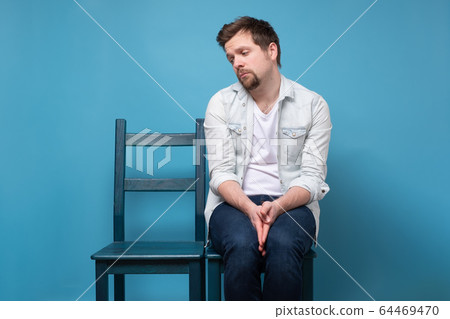 man sitting alone on chair. His girlfriend did not man sitting alone on chair. His girlfriend did not 64469470