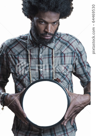 afroamerikaner in a checkered shirt holds the large white circle afroamerikaner in a checkered shirt holds the large white circle 64469530