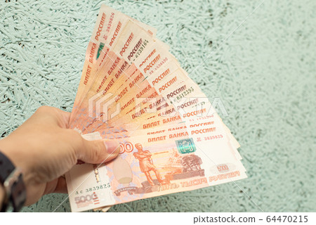 hand holding flat money russian ruble banknotes,business and finance concept. 64470215