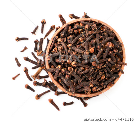 Clove spice in a wooden plate on a white Clove spice in a wooden plate on a white 64471116