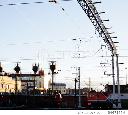 landscape with railway with trains, lot of steel rafters at sunset close up landscape with railway with trains, lot of steel rafters at sunset close up 64471334