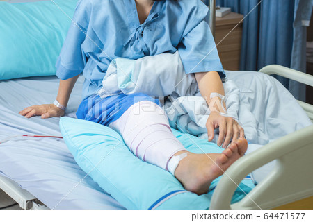 Asian senior or elderly old woman patient with bandage compression knee brace support injury on bed Asian senior or elderly old woman patient with bandage compression knee brace support injury on bed 64471577