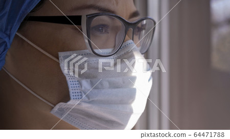 Serious Woman In Mask And Glasses Looking At Window Serious Woman In Mask And Glasses Looking At Window 64471788