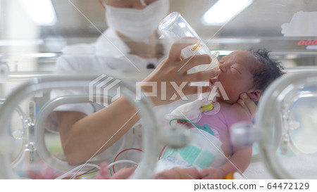 Newborn newborn incubator working hard with incubator Newborn newborn incubator working hard with incubator 64472129