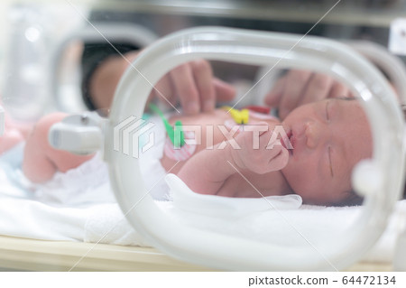 Newborn newborn incubator working hard with incubator Newborn newborn incubator working hard with incubator 64472134