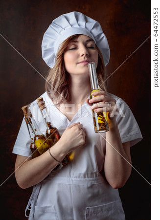 Young beautiful girl in a chef uniform with small 64472553