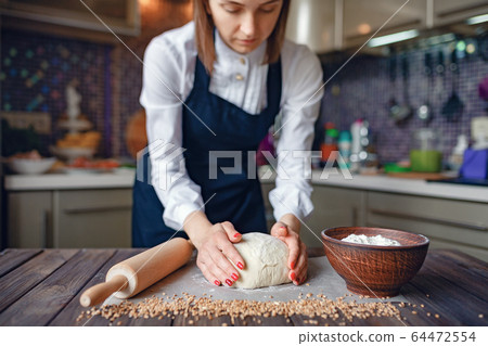 Crop woman cooking in apron 64472554