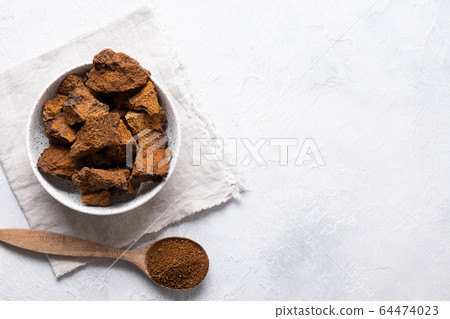 Chaga Birch Mushrooms in bowl on light table. 64474023