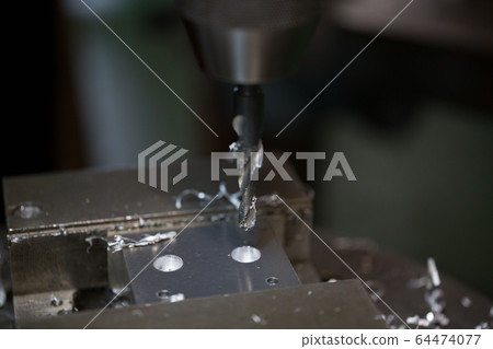 Drilling with a drill machine Drilling with a drill machine 64474077