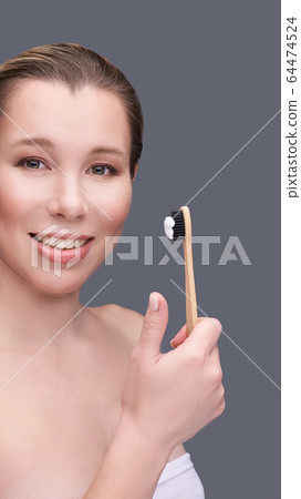 Girl hold toothbrush with toothpaste. Oral home routine Girl hold toothbrush with toothpaste. Oral home routine 64474524