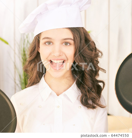 Young girl at kitchen. Little cook chef. Cute female portrait. Baker smile 64474550