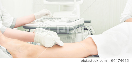 Doctor ultrasound knee test. Scan medical equipment. Diagnosis ultrasound foot Doctor ultrasound knee test. Scan medical equipment. Diagnosis ultrasound foot 64474623