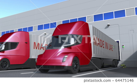 Modern semi-trailer trucks with MADE IN UAE text being loaded or unloaded at warehouse. United Arab Emirates business related 3D rendering 64475146