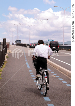 High school student going to school by bicycle High school student going to school by bicycle 64478197