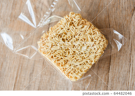 instant noodles in package on wooden background - instant noodles in package on wooden background - 64482046