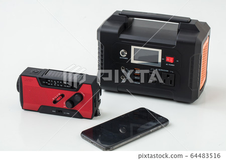 Tools for emergency disaster on a white background Portable power supply Flashlight Radio Charger Mobile phone 64483516