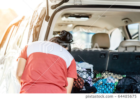 Woman cleaning with a blowers and microfiber wipe the car polishing after car wash. Woman cleaning with a blowers and microfiber wipe the car polishing after car wash. 64485675