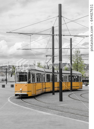 Yellow tram walking down 64487631