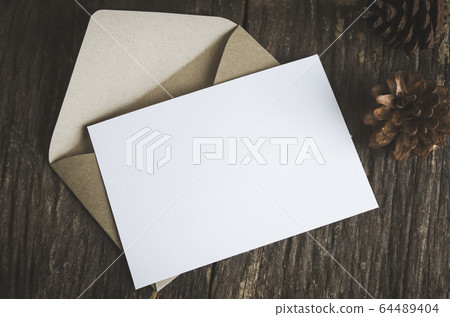 Blank white paper card with brown envelop and pine Blank white paper card with brown envelop and pine 64489404