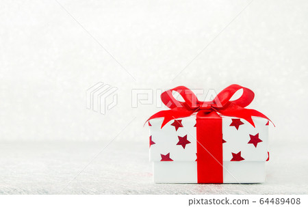 Close up of white gif box with red star pattern Close up of white gif box with red star pattern 64489408
