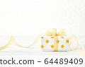 Close up of white gif box with golden star pattern 64489409