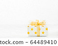Close up of white gif box with golden star pattern 64489410