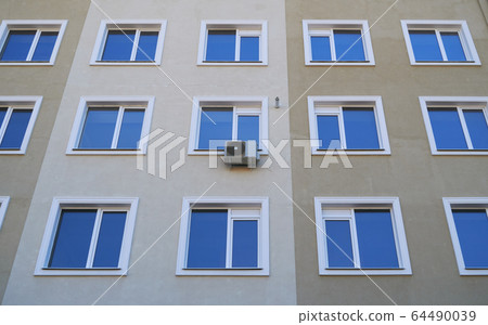 one air conditioner outside unit on a facade of one air conditioner outside unit on a facade of 64490039