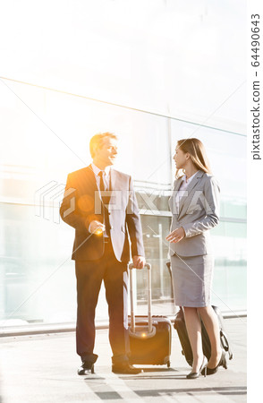 Business people talking while walking with their 64490643