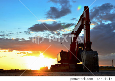 Large tracked excavator on a construction site Large tracked excavator on a construction site 64491917