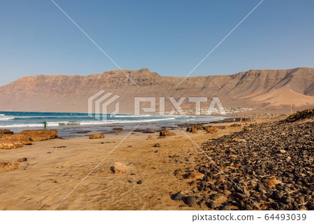 Famara beach, scenic landscape with ocean and mountains in Lanzarote, Canary islands 64493039