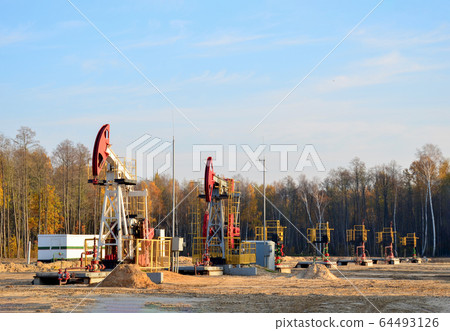 Oil drilling derricks at desert oilfield for fossil fuels output and crude oil production Oil drilling derricks at desert oilfield for fossil fuels output and crude oil production 64493126