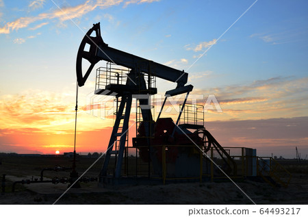 Oil drilling derricks at desert oilfield for fossil fuels output and crude oil production Oil drilling derricks at desert oilfield for fossil fuels output and crude oil production 64493217