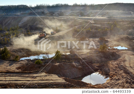 Dump truck transports sand and other minerals in the mining quarry Dump truck transports sand and other minerals in the mining quarry 64493339
