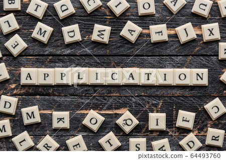 Application word made of square letter word on wooden background. 64493760