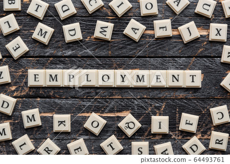 Employment word made of square letter word on wooden background. 64493761