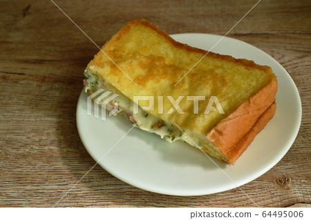 French toast sandwich stuffed bacon and cheese on plate French toast sandwich stuffed bacon and cheese on plate 64495006