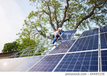 Stand-alone exterior solar panel system installation, renewable green energy generation concept. Stand-alone exterior solar panel system installation, renewable green energy generation concept. 64495338