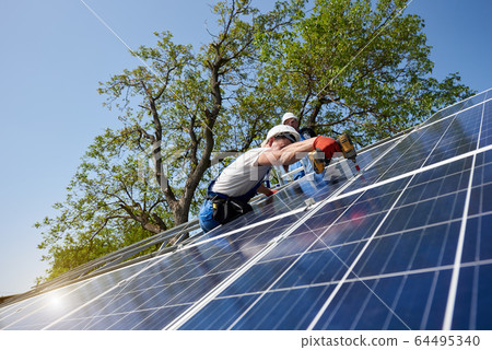 Stand-alone exterior solar panel system installation, renewable green energy generation concept. Stand-alone exterior solar panel system installation, renewable green energy generation concept. 64495340