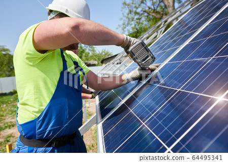 Stand-alone exterior solar panel system installation, renewable green energy generation concept. Stand-alone exterior solar panel system installation, renewable green energy generation concept. 64495341