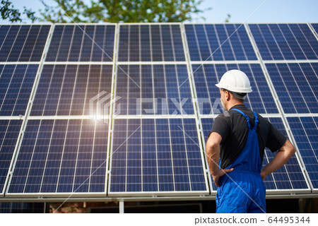 Stand-alone exterior solar panel system installation, renewable green energy generation concept. Stand-alone exterior solar panel system installation, renewable green energy generation concept. 64495344